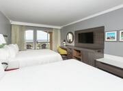 Two Queen Beds, Flat Screen TV, and Work Desk in Guest Room with Balcony Access and Beach View