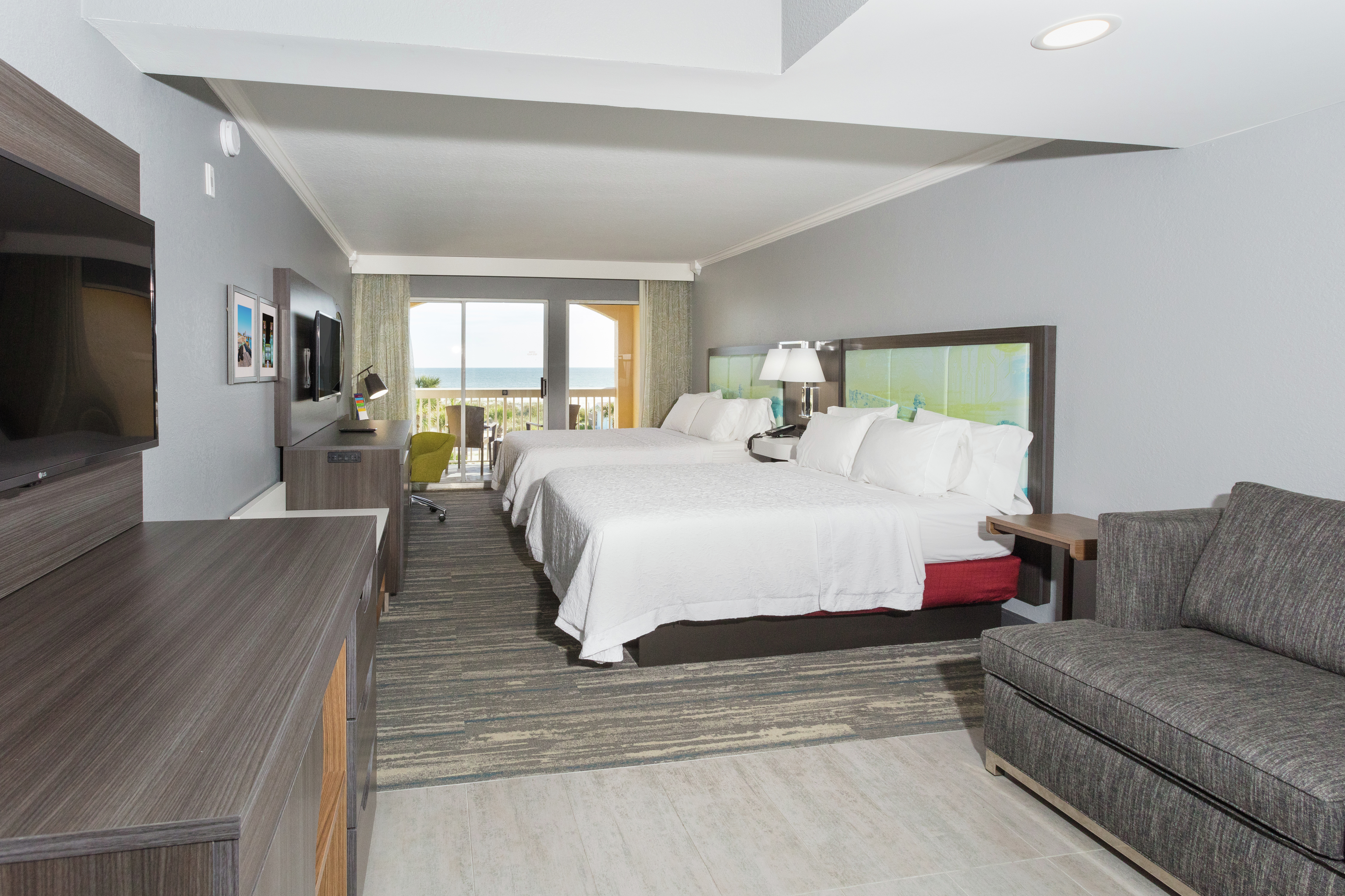 Two Queen Beds and Living Area in Suite with Balcony Access and Ocean View
