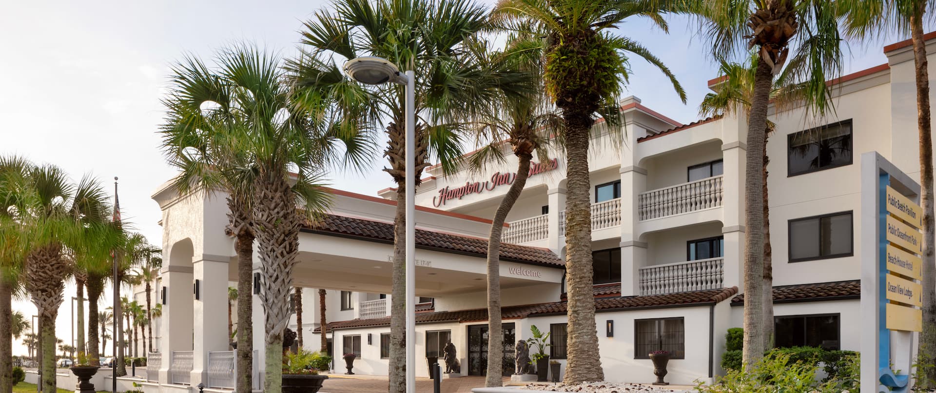 hotel exterior, front entrance, palm trees