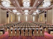 rows of tables and chairs in a ballroom