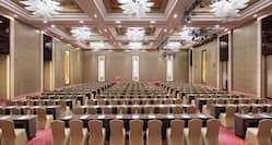 rows of tables and chairs in a ballroom