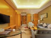 a suite living room with sofas and tv