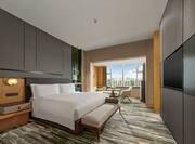 Deluxe Room with One King Bed TV Seating Area and City View