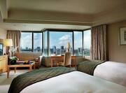 Two Twin Beds, Desk and View of City