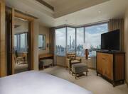 One King Bed Guest Bedroom with Armchair, Footrest, HDTV and City View