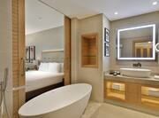 One King Bed Guest Bedroom and Bathroom with Tub and Vanity