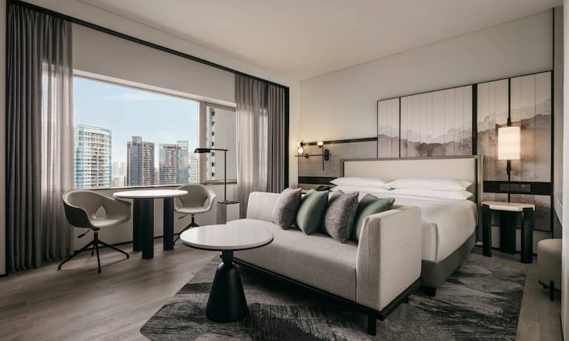 King Executive Suite Bedroom with Sitting Area and City View