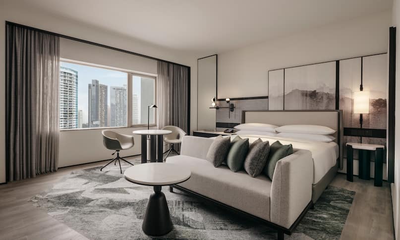 Suite Living Area with a King Bed and City View-next-transition
