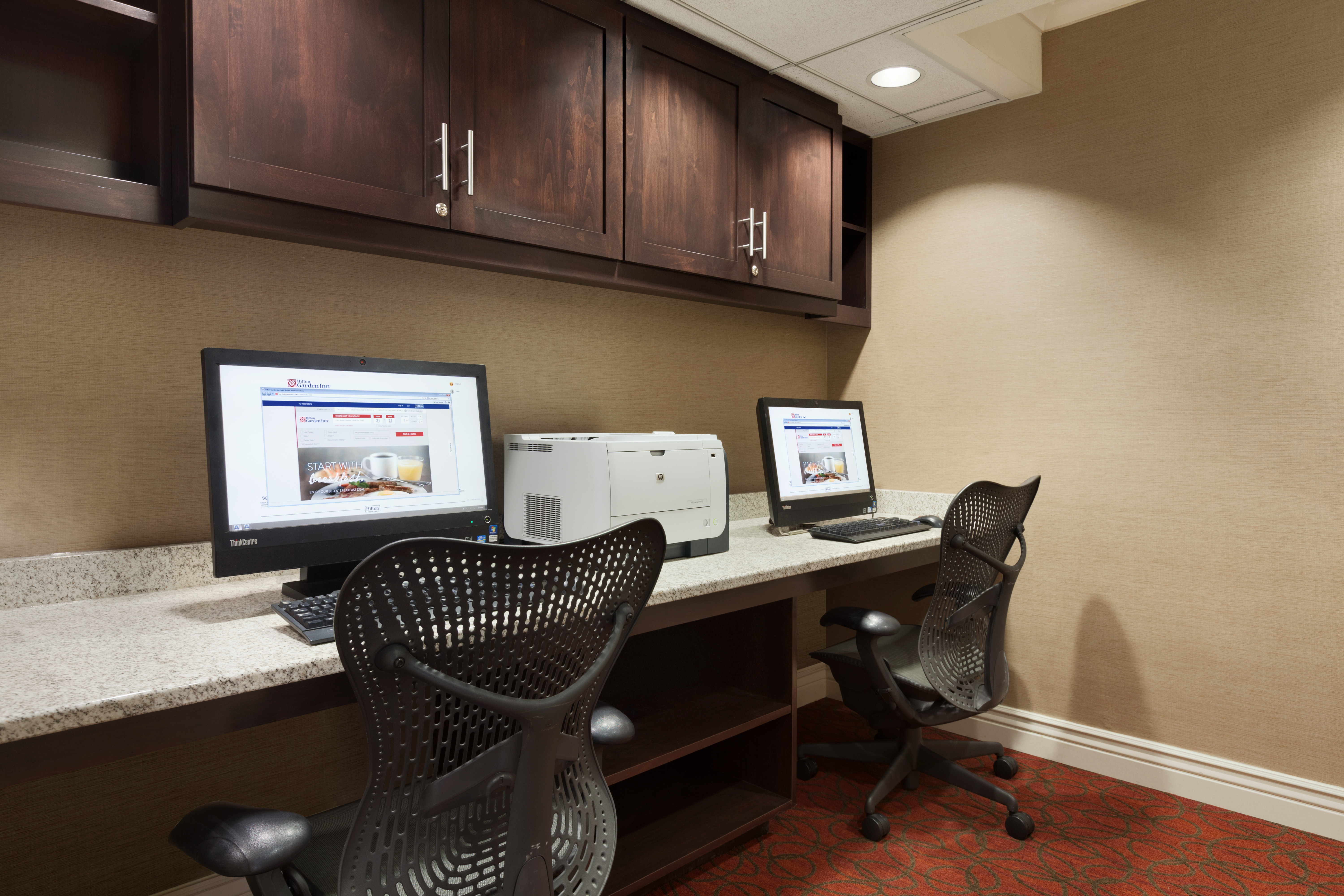 Business Center With Overhead Cabinets, Two Computer Workstations, Ergonomic Chairs, and Printer