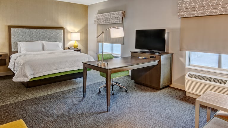 Bed in room with workdesk