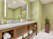 Junior Suite Bathroom with Dual Vanity and Large Lit Mirror