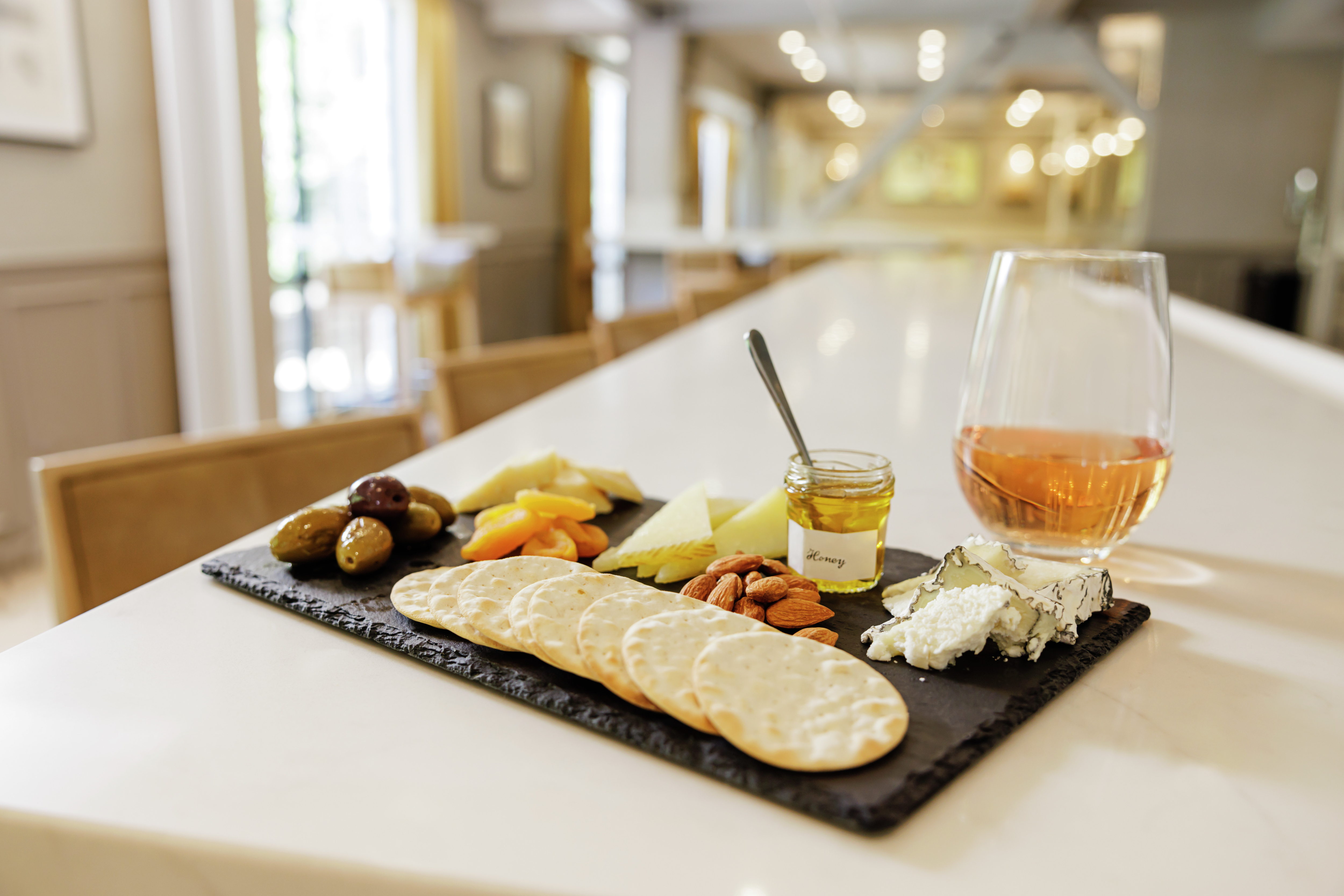 Cheese board on table, with drink