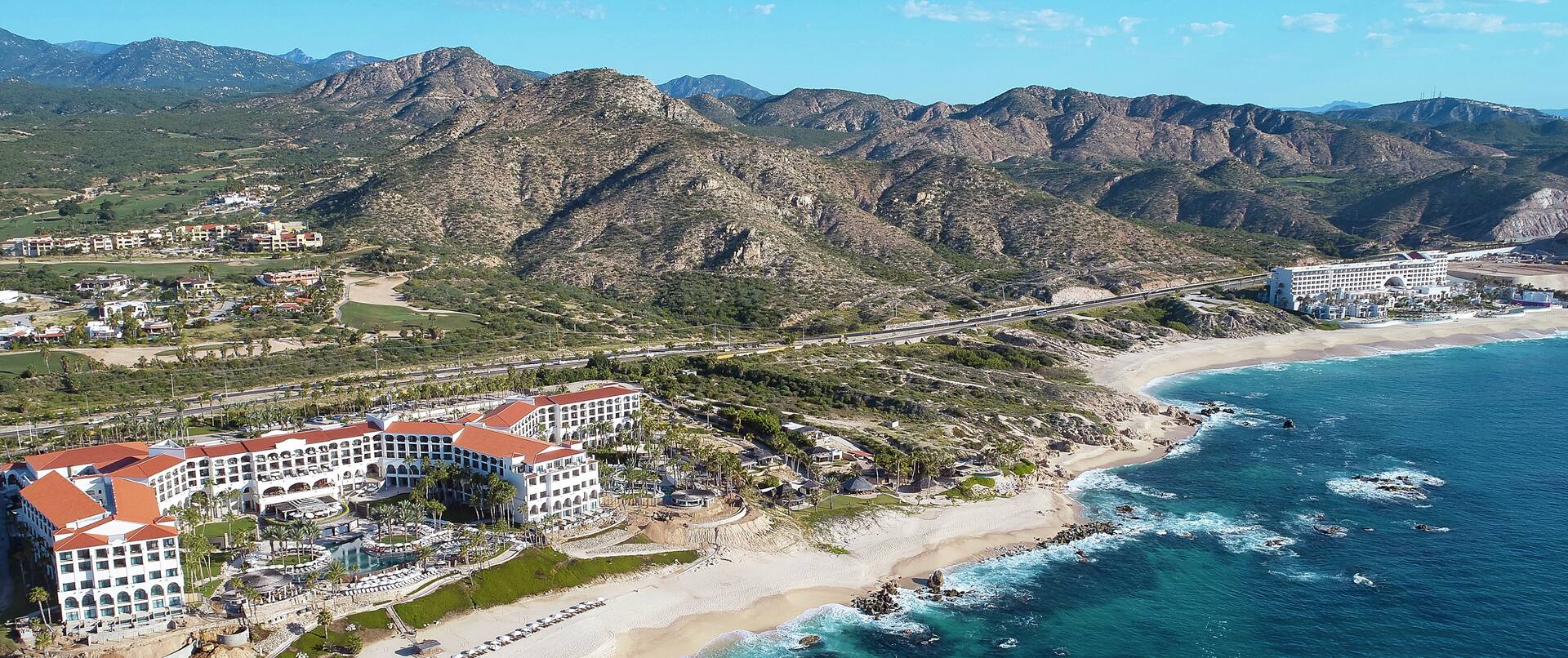 Aerial View of Hotel, Beach and Surrounding Mountains