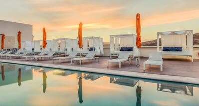 Poolside lounge chairs and sunset view