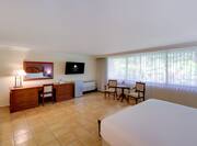 Suite with Large Bed Desk HDTV and Seating Area