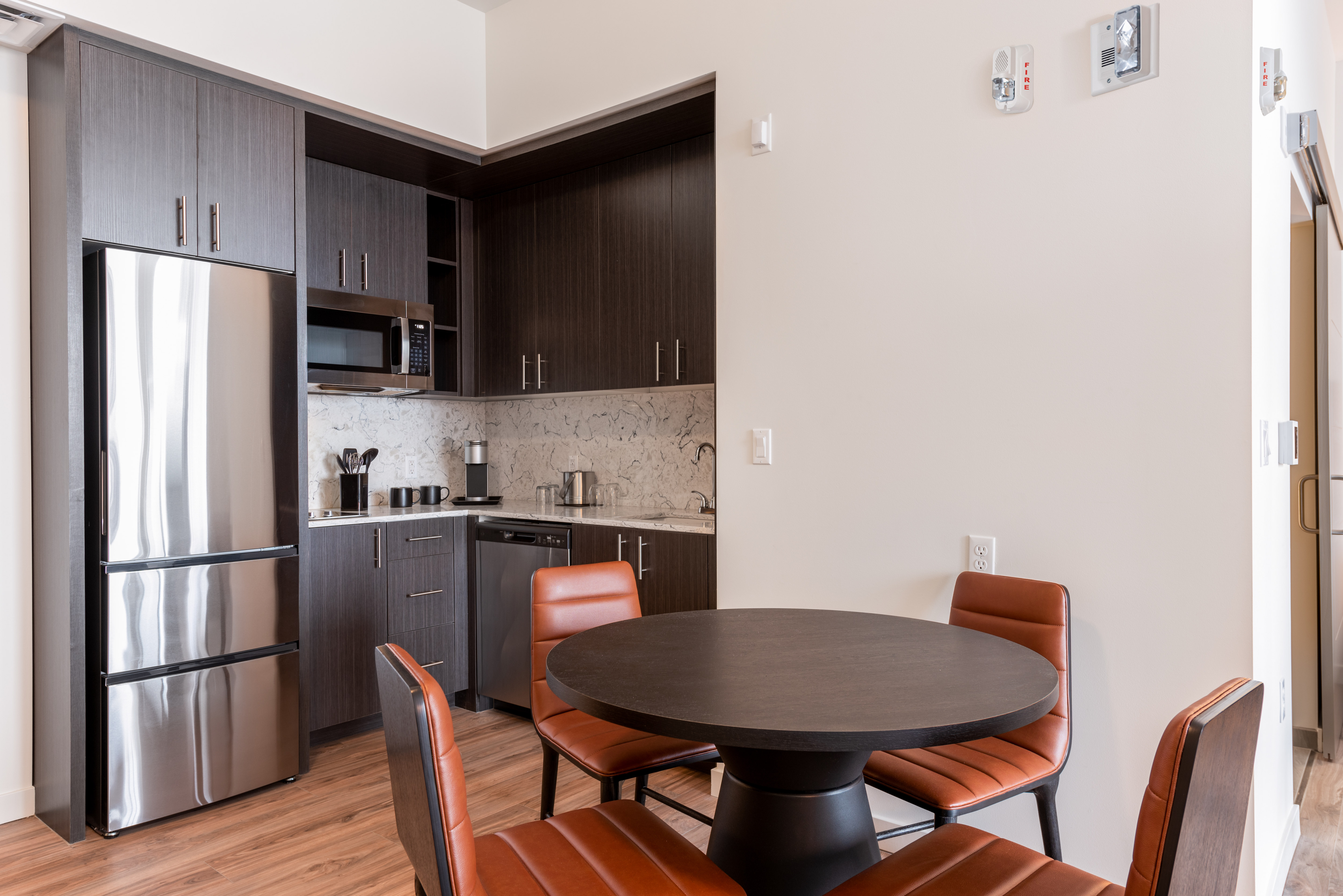 Suite Dining Area and Kitchen with Stainless Appliances