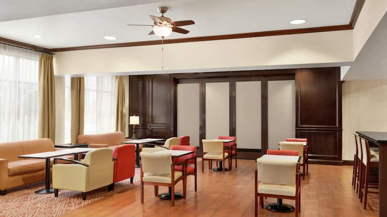 Spacious hotel lobby featuring ample comfortable seating for guests.