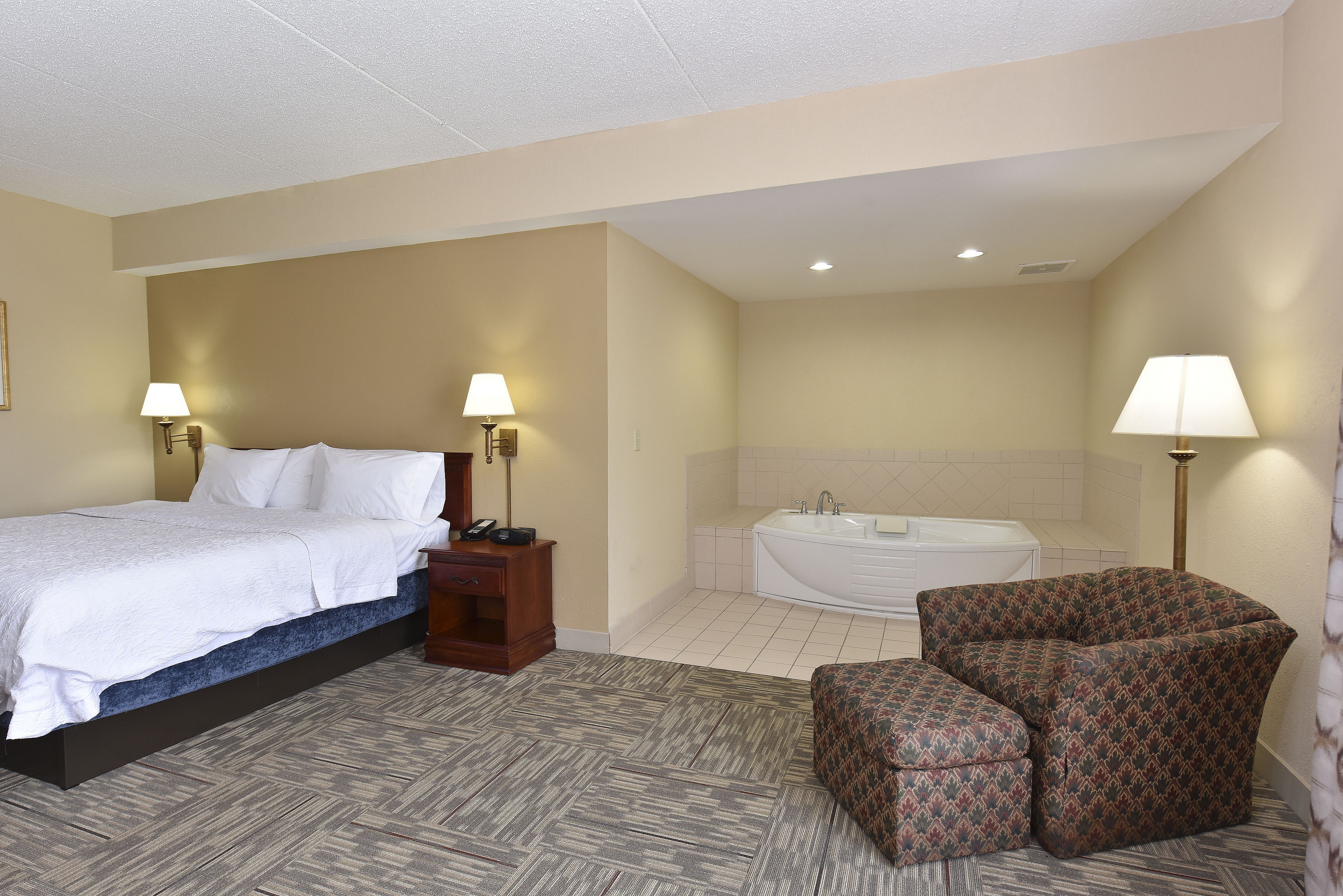 Guest Room with King Bed and Adjacent Whirlpool Area