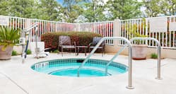 Daytime View of Two Chairs by Outdoor Whirlpool Spa