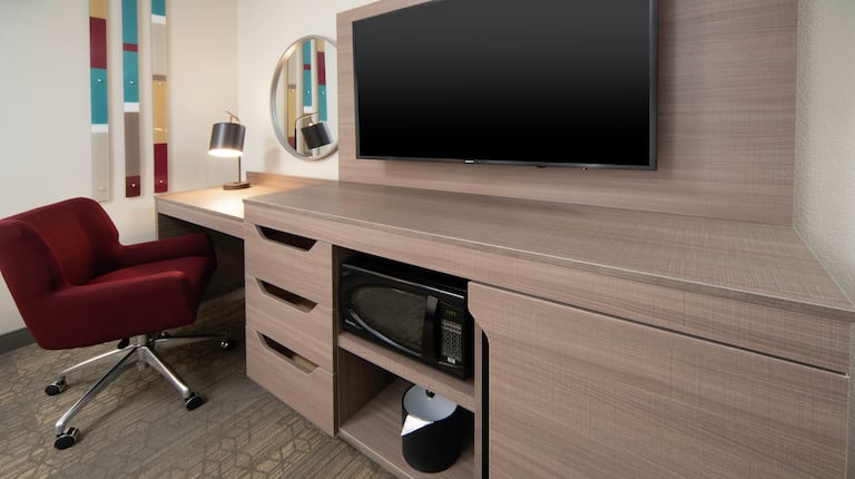 Guestroom Entertainment Area with Wall Mounted TV and Work Desk