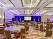 DoubleTree Hotel Meeting Room with Projector Screen, Round Tables, and Chairs