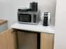 coffee maker, microwave, and mini fridge in guest room