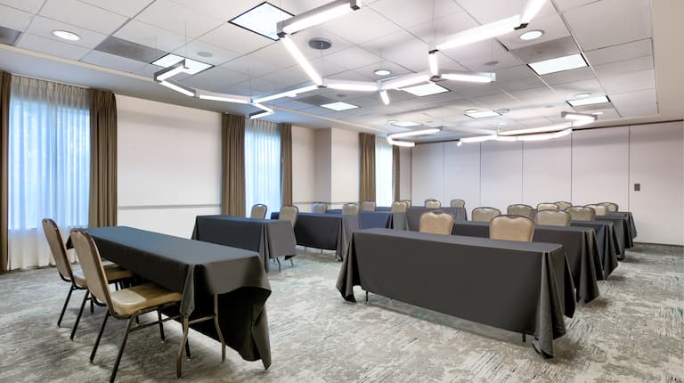 meeting room with rows of tables and chairs