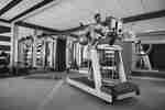 Man running on a treadmill in a modern hotel gym
