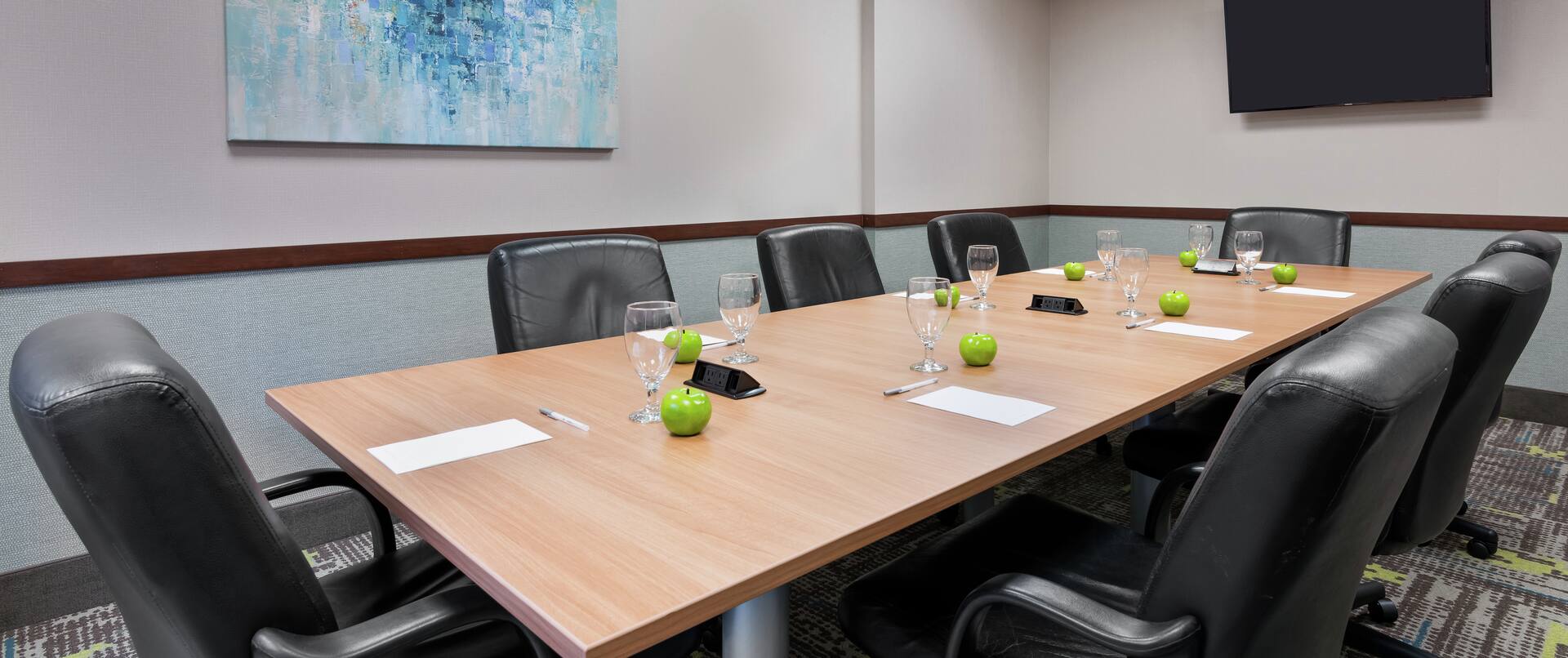 Boardroom with Meeting Table, Leather Office Chairs and Wall Mounted TV