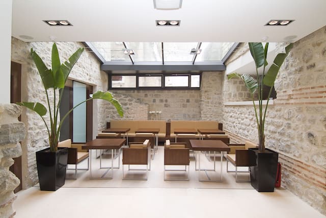 Lobby area with comfortable seating area, tables and chairs