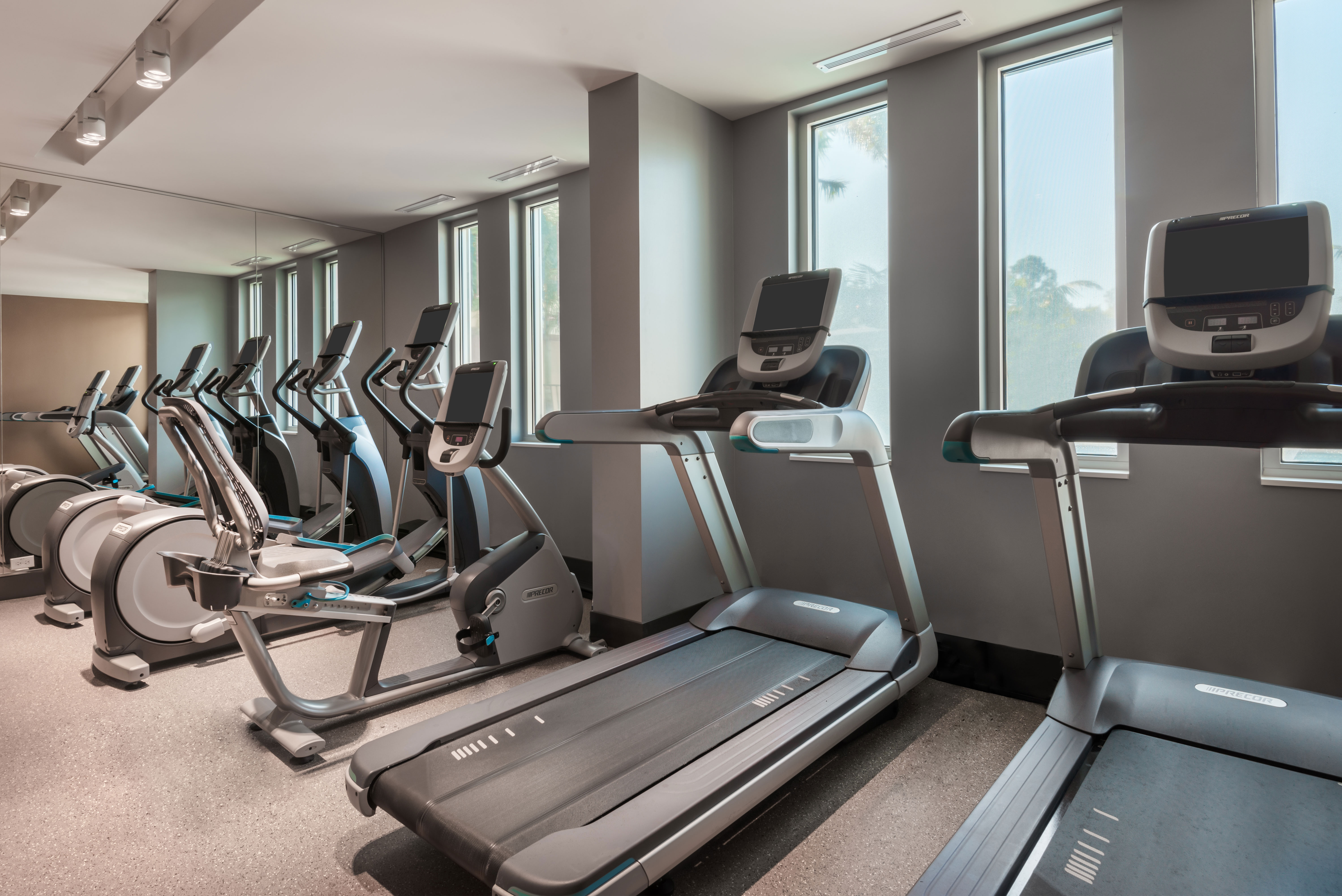 Fitness Center with Mirrored Wall with Cardio Equipment and Outside View