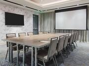 Boardroom-Style Setup With TV, Presentation Screen, and Seating for 12 people.
