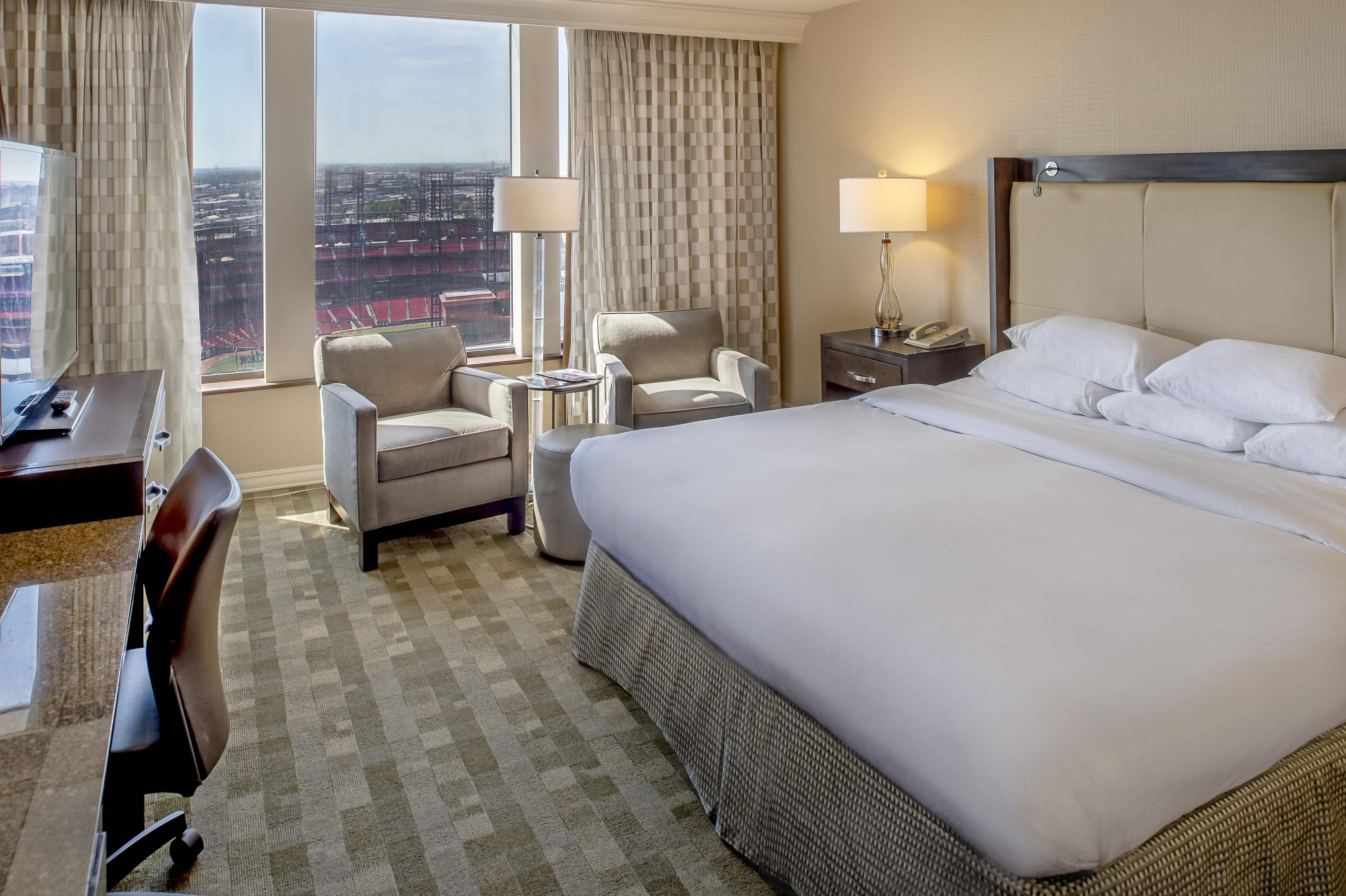 Accessible Guestroom with King Bed, Work Desk, Chairs and Outside View of Stadium