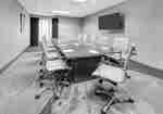Boardroom with Large Meeting Table, Office Chair and Wall Mounted TV