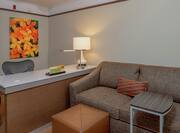  Wall Art, Work Desk, Sofa, TV, and Entry in Suite Sitting Area