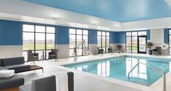 an indoor pool and seating area