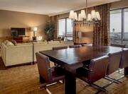 Presidential Suite Living Are with Dining Table, Couch, Television and Outside View