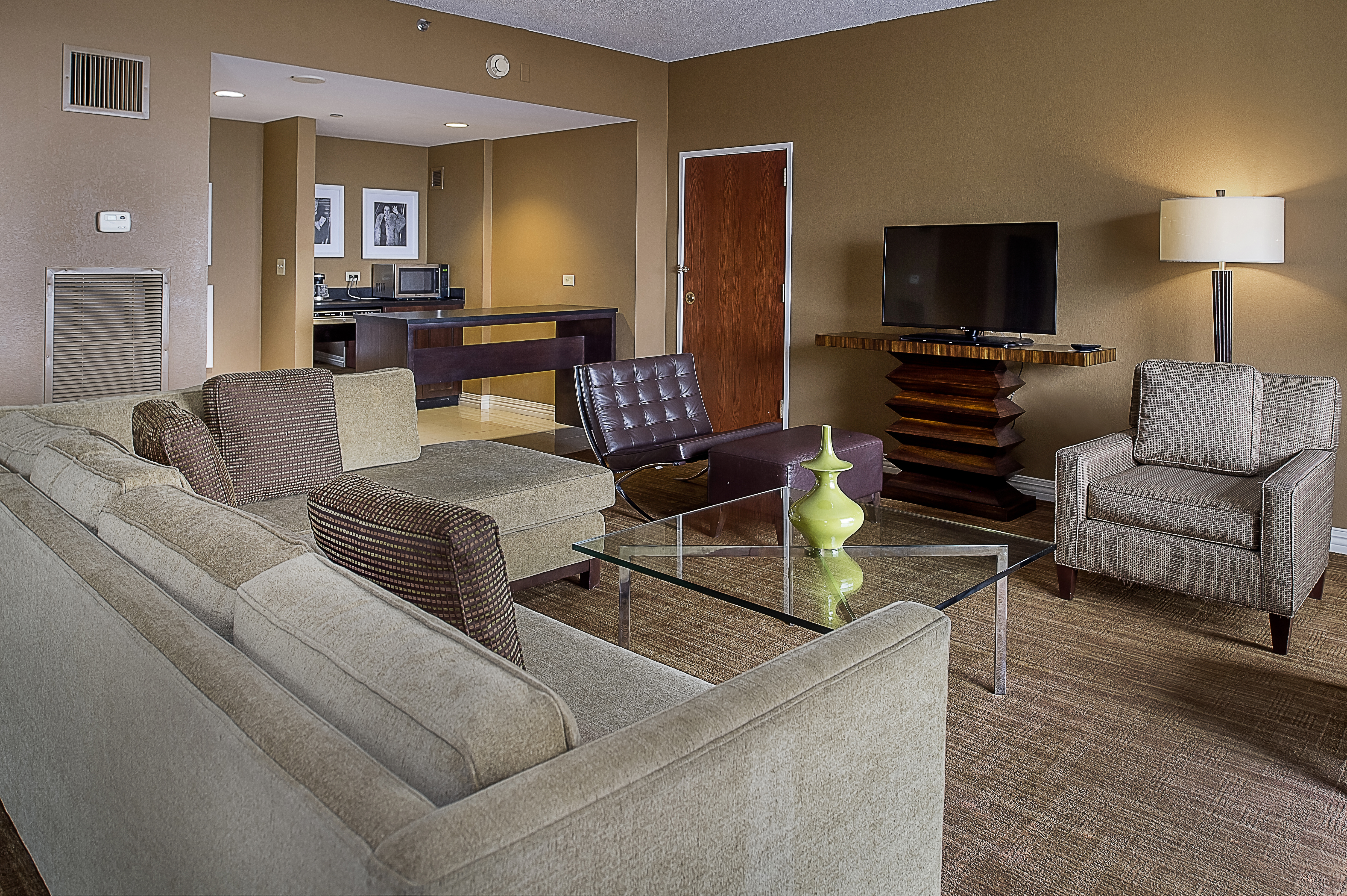 Presidential Suite Living Room with Couch, Chairs, Television and Kitchen Area