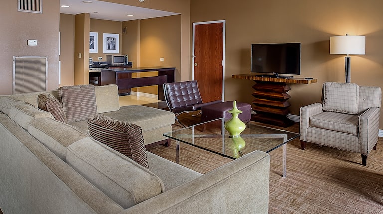 Presidential Suite Living Room with Couch, Chairs, Television and Kitchen Area