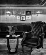  A cozy living room featuring a leather chair beside a stylish table