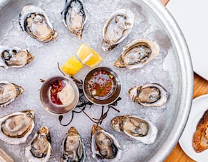 Oysters on a plate with dipping sauces