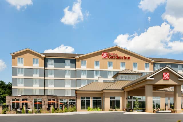 Front hotel exterior with circle drive under covered entrance