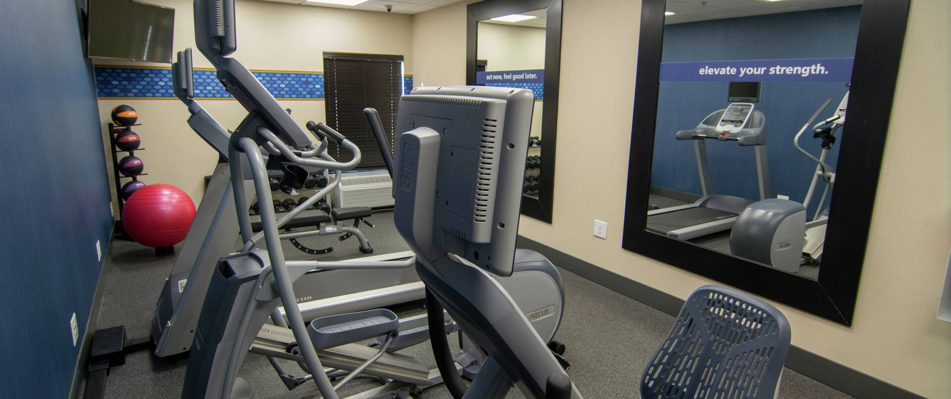Fitness Center with Elliptical Machines, Treadmills, Mirrors, and Room Technology