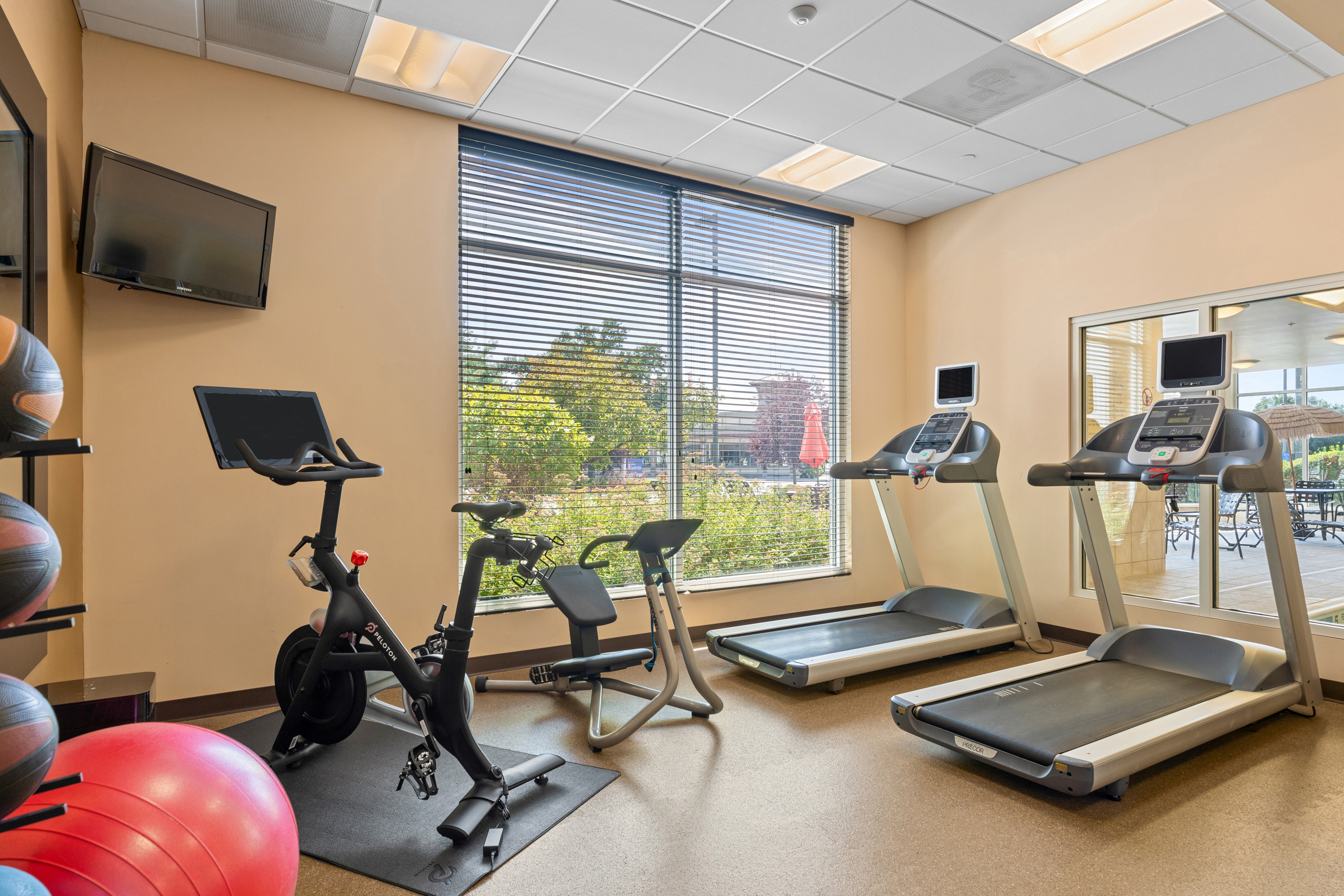 on site fitness center, peloton bike, treadmills, yoga ball