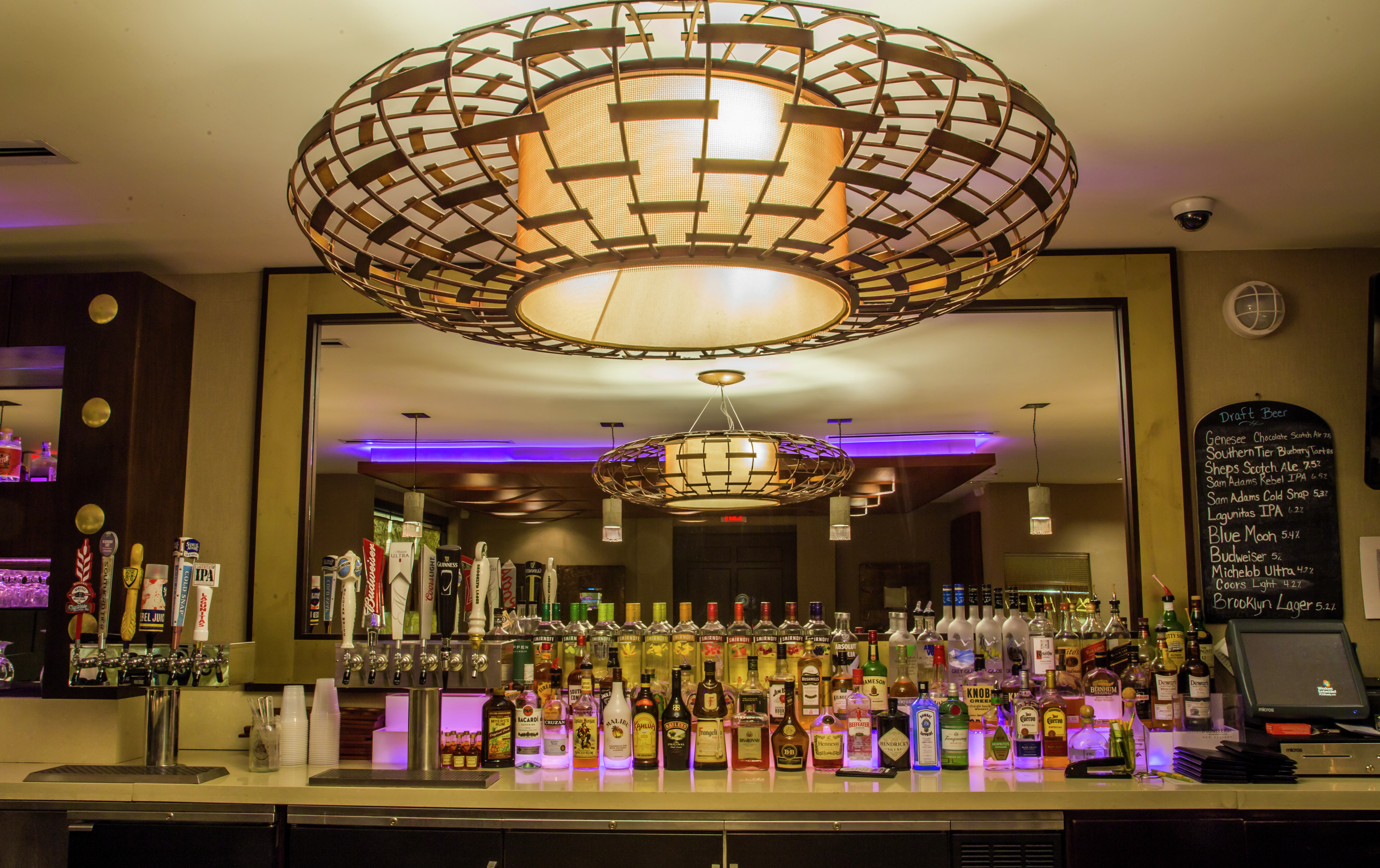 Round Wire Decorated Light Above Refinery Bar with Purple Accent Lights