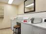 Coin operated guest laundry with access to multiple machines, laundry soap, bleach, and fabric softeners.