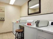 Coin operated guest laundry with access to multiple machines, laundry soap, bleach, and fabric softeners.