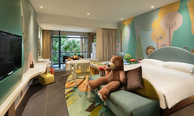 Guest Family Room with King Bed, Child Bed, Wall Mounted HDTV and Large Teddy Bear-next-transition