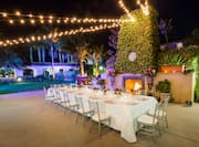 Hotel Garden Terrace at Night with Elegant Table and Seating 