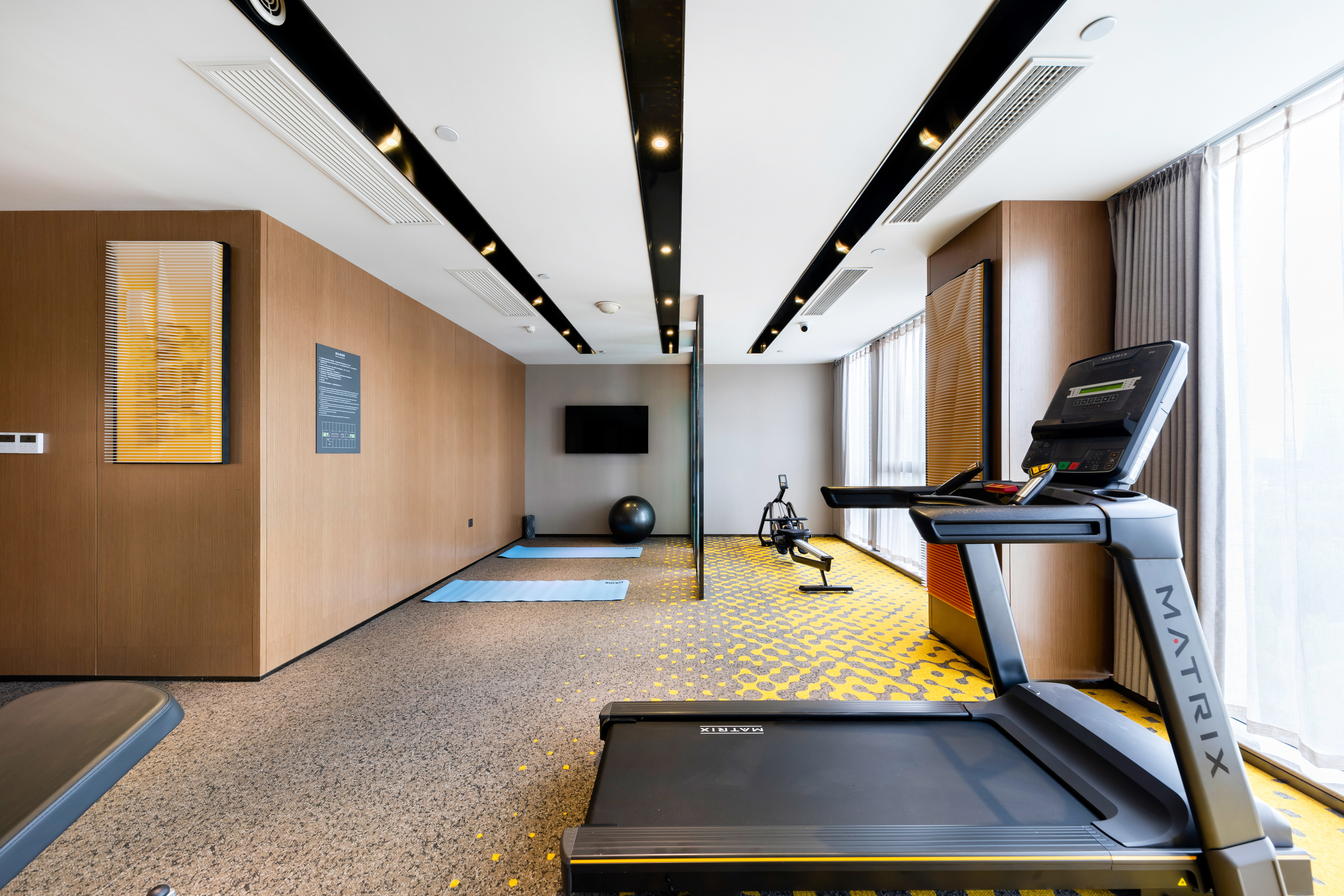 Fitness center with treadmill and TV